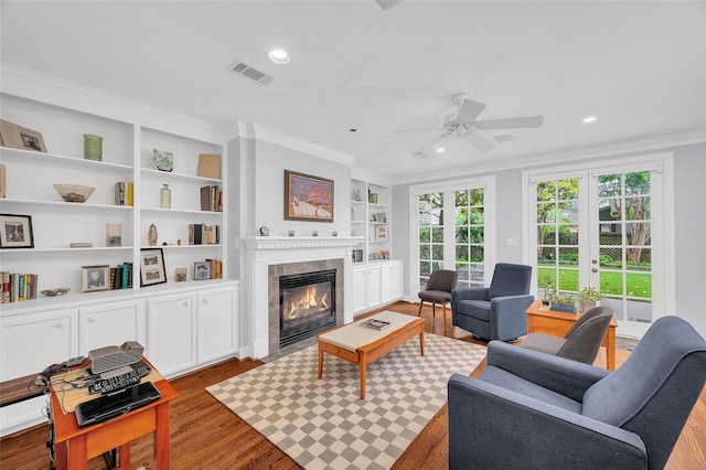 3509 Gramercy St, Houston, TX 77025 - living area with crown molding, wood finished floors, a fireplace, built in features, and recessed lighting