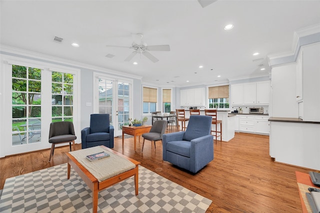 3509 Gramercy St, Houston, TX 77025 - living room with ornamental molding, light wood-type flooring, ceiling fan, and recessed lighting