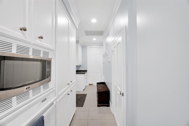 3509 Gramercy St, Houston, TX 77025 - hallway with light tile patterned flooring, crown molding, and recessed lighting