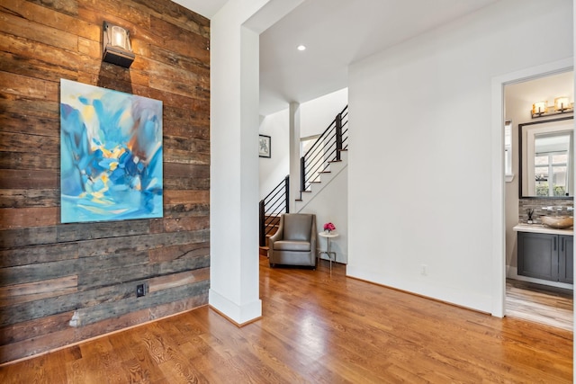 815 E 27th St, Houston, TX 77009 - unfurnished living room with wood finished floors, wooden walls, stairs, recessed lighting, and baseboards