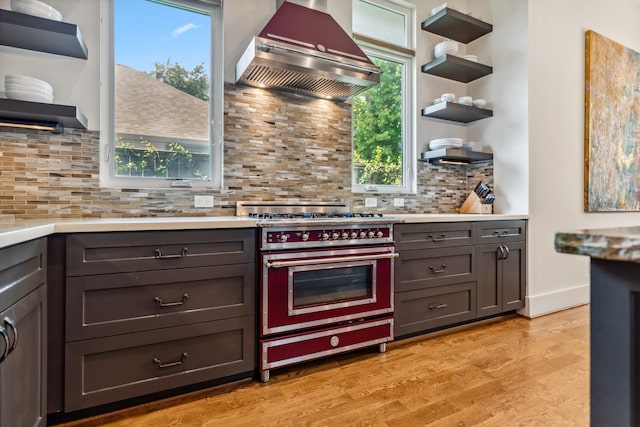 815 E 27th St, Houston, TX 77009 - kitchen featuring open shelves, range with gas cooktop, island range hood, and light wood-style floors