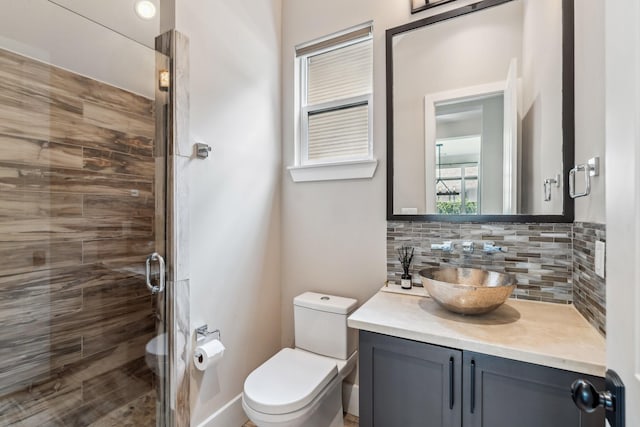815 E 27th St, Houston, TX 77009 - bathroom featuring toilet, vanity, tasteful backsplash, and a stall shower