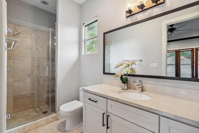815 E 27th St, Houston, TX 77009 - bathroom with toilet, vanity, ceiling fan, a stall shower, and tile patterned floors