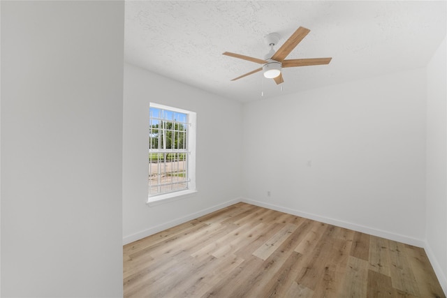 3906 Simsbrook Dr, Houston, TX 77045 - unfurnished room featuring light wood-style floors, ceiling fan, and a textured ceiling