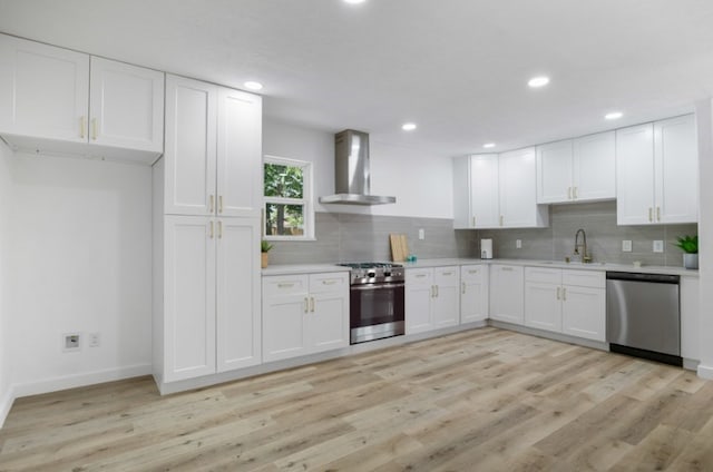3906 Simsbrook Dr, Houston, TX 77045 - kitchen featuring wall chimney exhaust hood, stainless steel appliances, light countertops, decorative backsplash, and recessed lighting