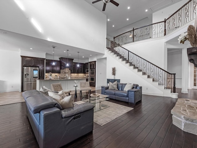 19003 Cove Manor Dr, Cypress, TX 77433 - living area featuring a ceiling fan, dark wood finished floors, stairs, a high ceiling, and baseboards