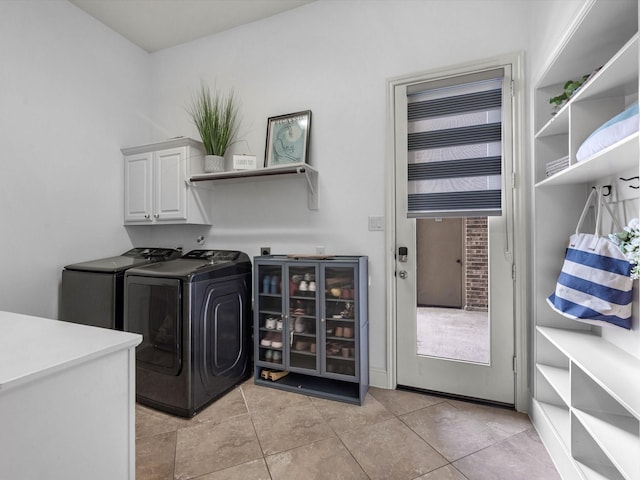 19003 Cove Manor Dr, Cypress, TX 77433 - laundry room with cabinet space, independent washer and dryer, and light tile patterned floors