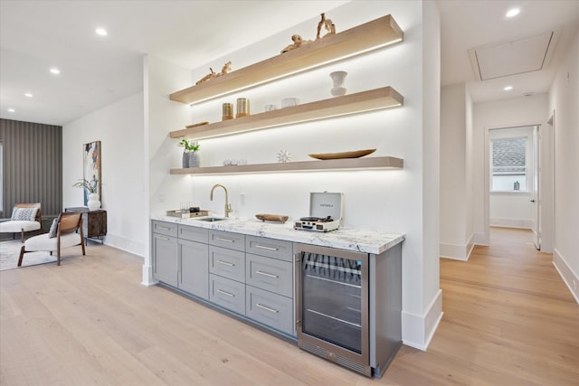 806 Holton St, Bellaire, TX 77401 - indoor wet bar with beverage cooler, light wood finished floors, baseboards, and recessed lighting