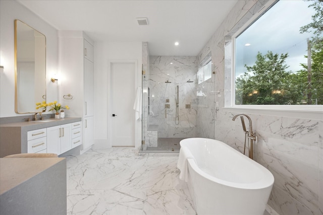 806 Holton St, Bellaire, TX 77401 - bathroom featuring a freestanding tub, a marble finish shower, vanity, marble tiled flooring, and recessed lighting