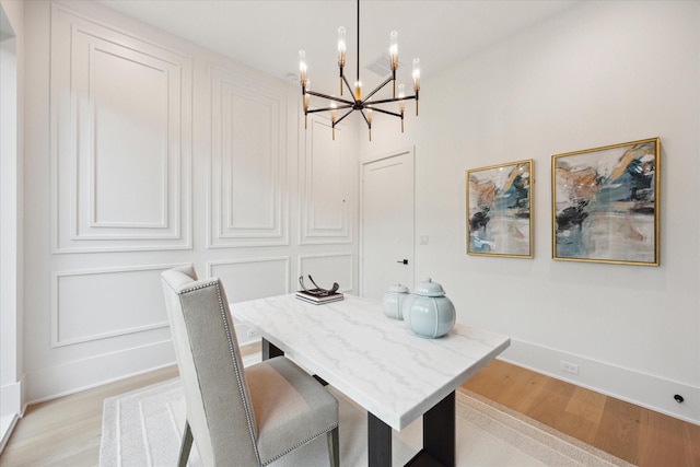 806 Holton St, Bellaire, TX 77401 - dining room with a chandelier, light wood-style floors, and baseboards