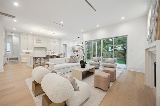 806 Holton St, Bellaire, TX 77401 - living area featuring light wood-style floors, recessed lighting, a fireplace, and baseboards