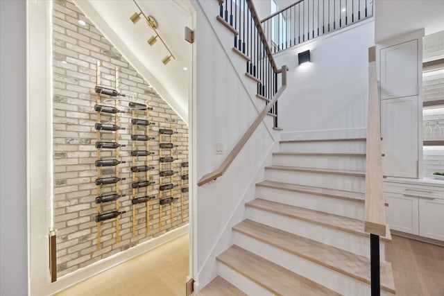 806 Holton St, Bellaire, TX 77401 - staircase with wood finished floors and brick wall
