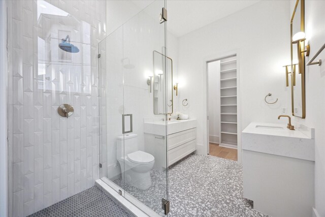 806 Holton St, Bellaire, TX 77401 - bathroom featuring a stall shower, vanity, toilet, and a spacious closet