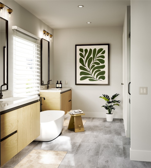 2594 W Tidwell Rd, Houston, TX 77091 - bathroom with two vanities, a freestanding tub, and recessed lighting