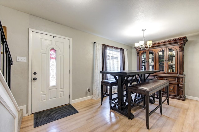18218 Heritage Ln Unit 8218, Houston, TX 77058 - dining space featuring a chandelier, light wood-style floors, and baseboards