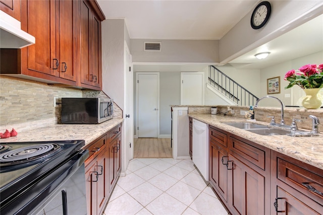 18218 Heritage Ln Unit 8218, Houston, TX 77058 - kitchen featuring under cabinet range hood, a sink, stainless steel microwave, dishwasher, and decorative backsplash