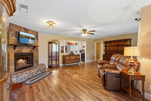 1518 14th Ave N, Texas City, TX 77590 - living room featuring baseboards, a fireplace, wood finished floors, and ceiling fan