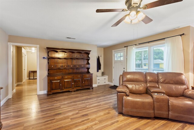 1518 14th Ave N, Texas City, TX 77590 - living room featuring light wood finished floors, ceiling fan, and baseboards