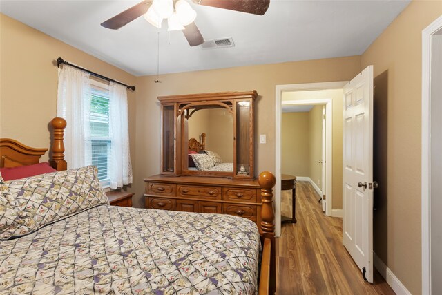1518 14th Ave N, Texas City, TX 77590 - bedroom featuring wood finished floors, ceiling fan, and baseboards