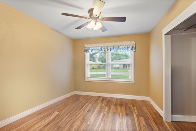 1518 14th Ave N, Texas City, TX 77590 - empty room with wood finished floors, baseboards, and ceiling fan