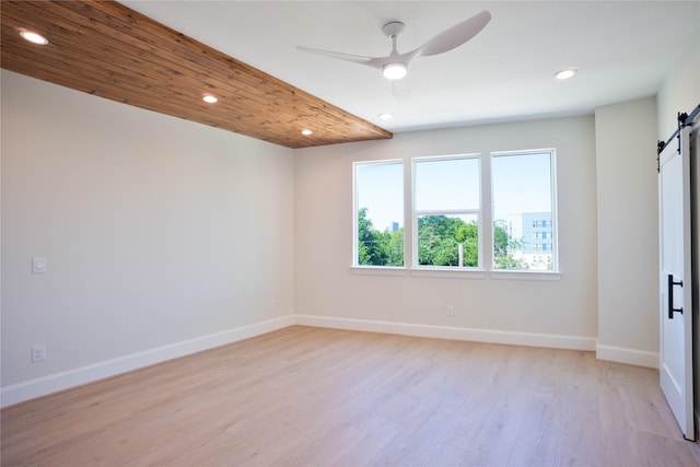 2117 Sauer St, Houston, TX 77004 - spare room featuring a barn door, recessed lighting, a ceiling fan, light wood-type flooring, and baseboards