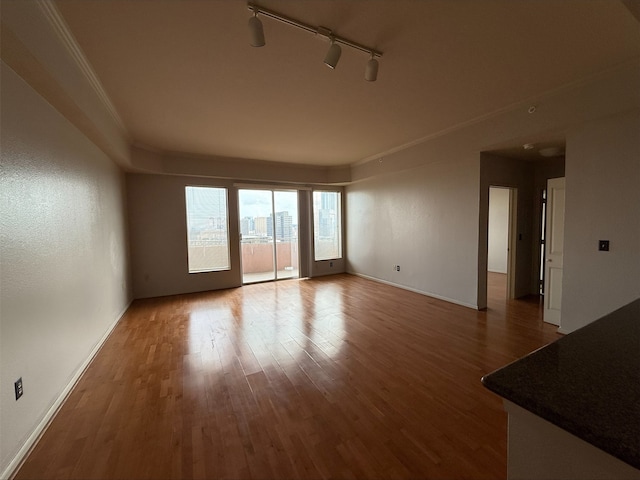 3505 Sage Rd Unit 1807, Houston, TX 77056 - unfurnished living room with rail lighting and wood finished floors