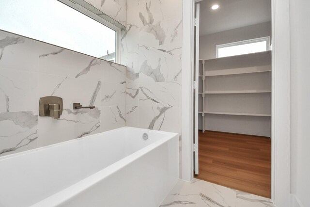 3002B Ventas Dr, Houston, TX 77047 - bathroom featuring a tub to relax in, marble finish floors, recessed lighting, and a shower