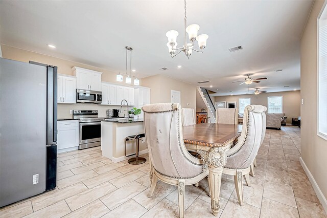 6702 Utah St, Houston, TX 77091 - dining space with ceiling fan, a chandelier, recessed lighting, baseboards, and light tile patterned flooring