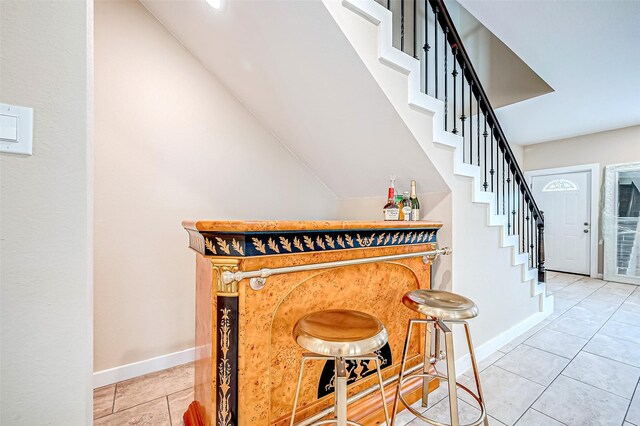 6702 Utah St, Houston, TX 77091 - indoor dry bar with stairs, light tile patterned flooring, and baseboards