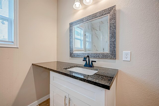 6702 Utah St, Houston, TX 77091 - bathroom featuring vanity, a textured wall, and baseboards