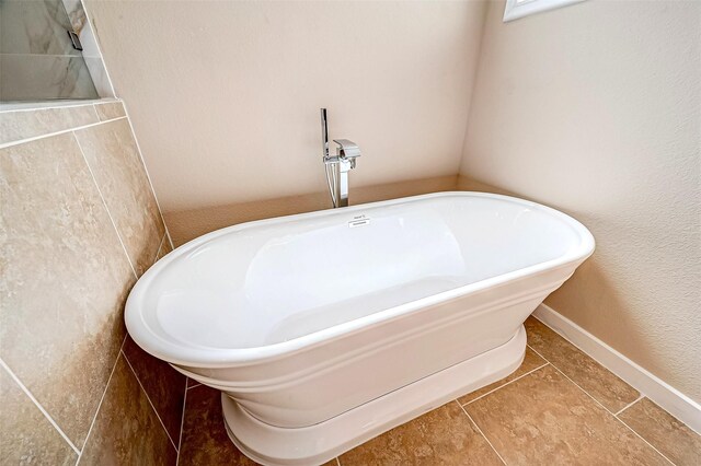 6702 Utah St, Houston, TX 77091 - full bath featuring a freestanding bath and tile patterned flooring
