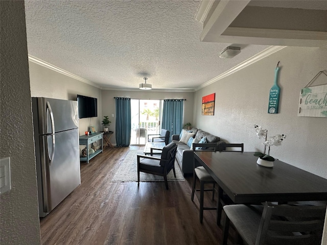 6300 Seawall Blvd Unit 9207, Galveston, TX 77551 - dining space with dark wood-type flooring, crown molding, a textured wall, and a textured ceiling