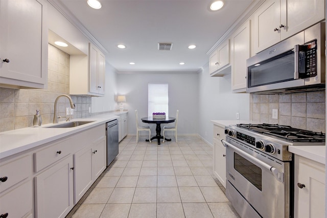 502 Enid St, Houston, TX 77009 - kitchen with appliances with stainless steel finishes, a sink, baseboards, tasteful backsplash, and recessed lighting