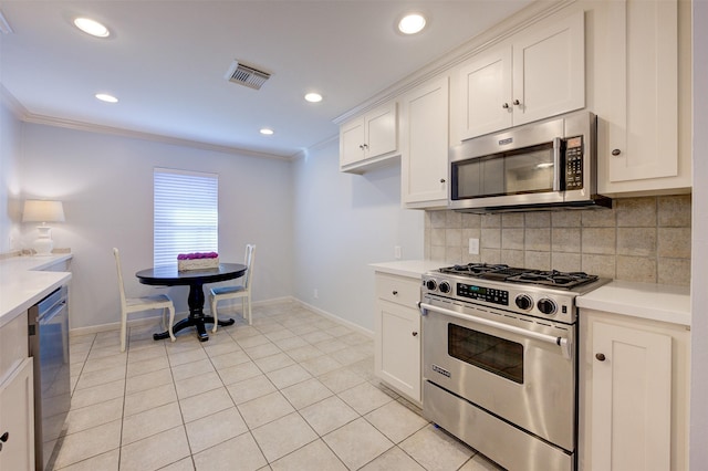 502 Enid St, Houston, TX 77009 - kitchen with stainless steel appliances, baseboards, backsplash, light countertops, and ornamental molding