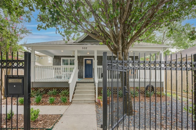 502 Enid St, Houston, TX 77009 - view of front of house with covered porch, a gate, and roof with shingles