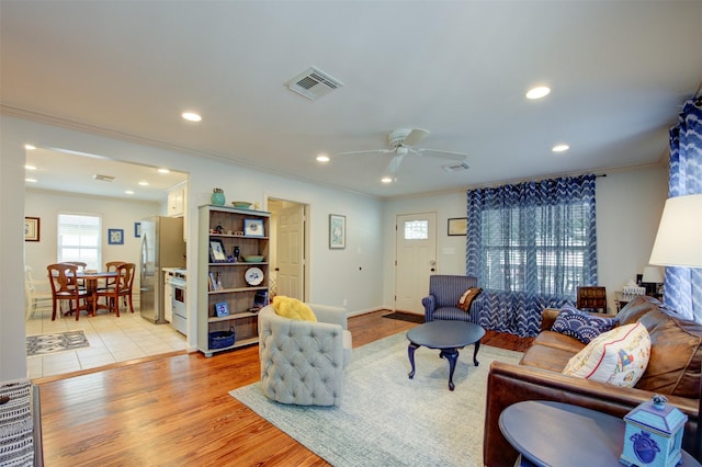 502 Enid St, Houston, TX 77009 - living room with crown molding, ceiling fan, recessed lighting, and light wood finished floors