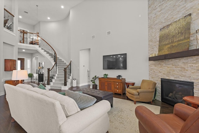 6602 Rochester Lake Loop, Katy, TX 77493 - living room featuring a high ceiling, dark wood-style flooring, stairway, baseboards, and a fireplace