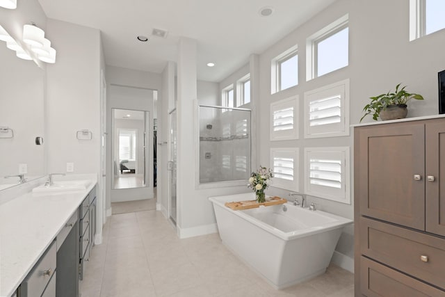6602 Rochester Lake Loop, Katy, TX 77493 - full bathroom featuring a stall shower, a freestanding bath, vanity, baseboards, and tile patterned floors