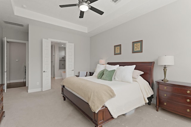6602 Rochester Lake Loop, Katy, TX 77493 - bedroom featuring light carpet, a raised ceiling, ensuite bathroom, ceiling fan, and baseboards