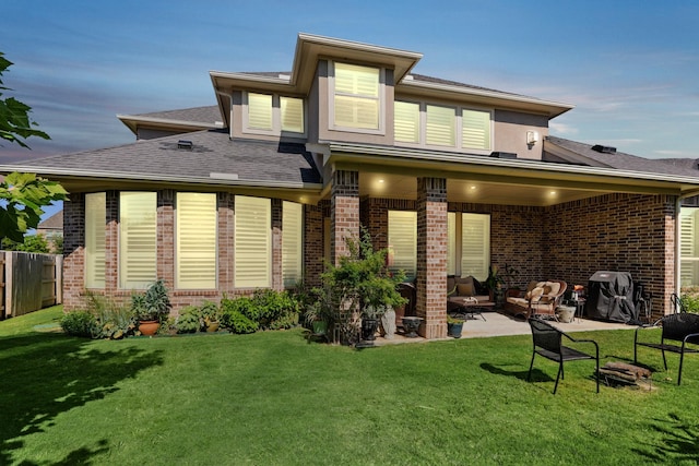 6602 Rochester Lake Loop, Katy, TX 77493 - rear view of property featuring brick siding, a patio, a shingled roof, and an outdoor living space