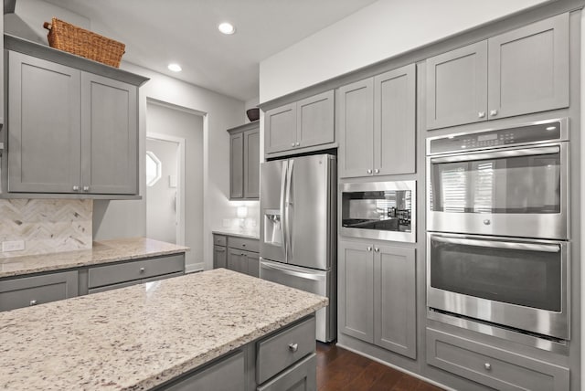 6602 Rochester Lake Loop, Katy, TX 77493 - kitchen with stainless steel appliances, gray cabinets, recessed lighting, dark wood-style floors, and light stone countertops
