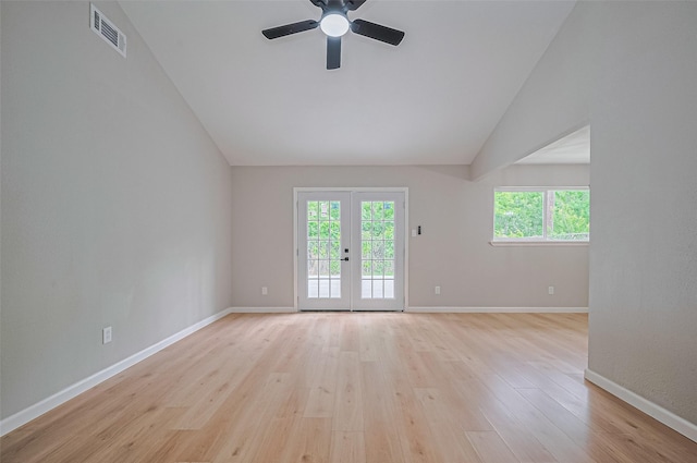10623 Dunvegan Way, Houston, TX 77013 - empty room with vaulted ceiling, plenty of natural light, a ceiling fan, baseboards, and light wood-type flooring