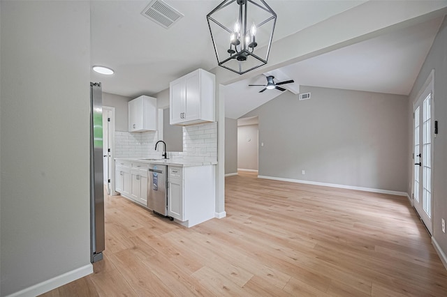 10623 Dunvegan Way, Houston, TX 77013 - kitchen with stainless steel appliances, a sink, a ceiling fan, white cabinetry, and decorative backsplash