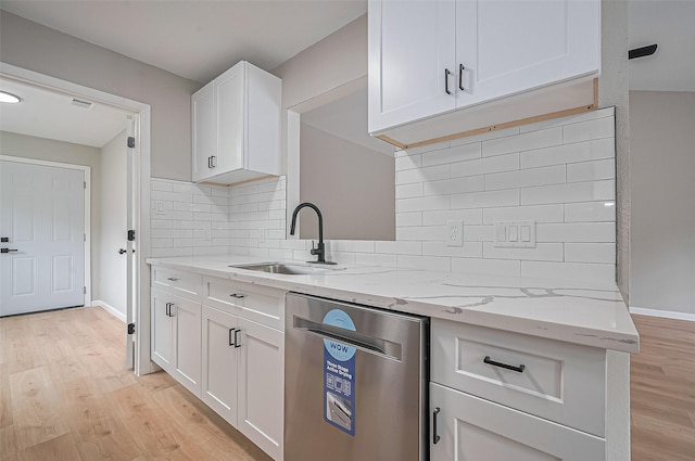 10623 Dunvegan Way, Houston, TX 77013 - kitchen with dishwasher, a sink, light wood-style floors, white cabinets, and backsplash
