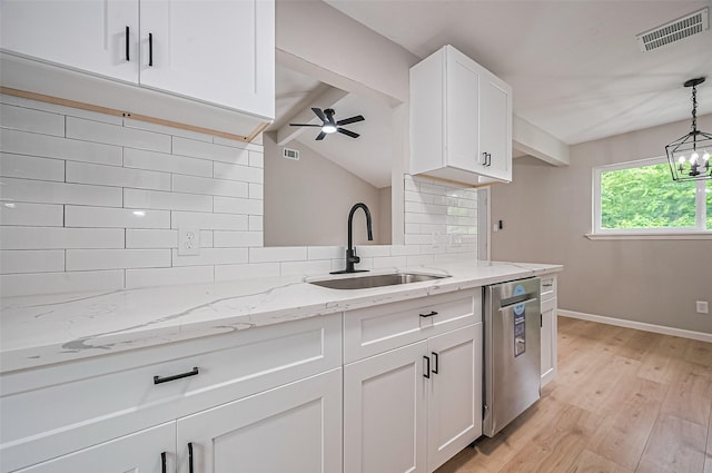 10623 Dunvegan Way, Houston, TX 77013 - kitchen featuring stainless steel dishwasher, a sink, light wood-style floors, and decorative backsplash