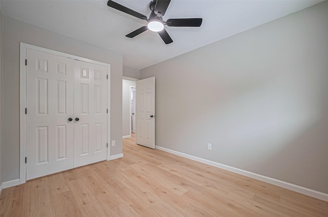 10623 Dunvegan Way, Houston, TX 77013 - unfurnished bedroom featuring baseboards, light wood-style floors, a closet, and ceiling fan
