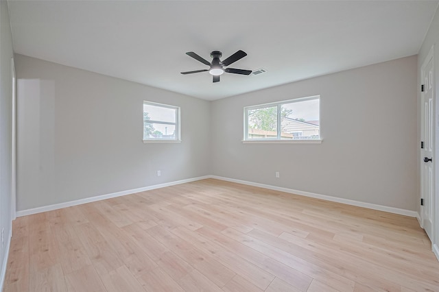10623 Dunvegan Way, Houston, TX 77013 - empty room with light wood-style floors, a ceiling fan, and baseboards