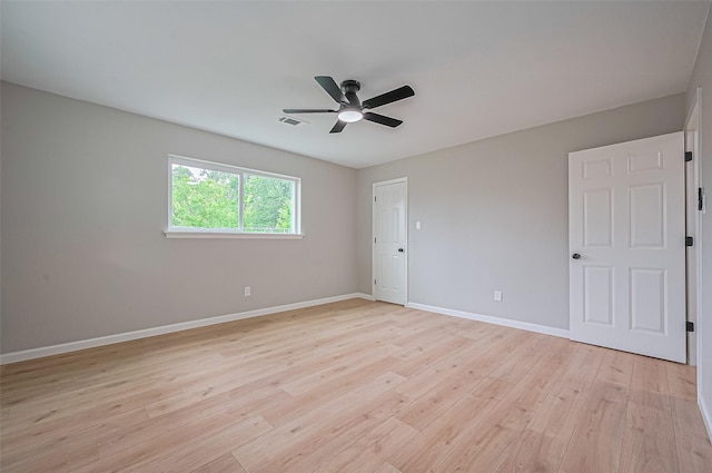 10623 Dunvegan Way, Houston, TX 77013 - spare room featuring light wood finished floors, ceiling fan, and baseboards
