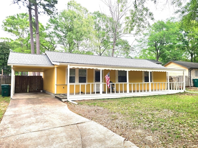 405 Wakefield Rd, Conroe, TX 77316 - ranch-style house with a porch, concrete driveway, a carport, and a shingled roof