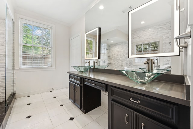 1938 Norfolk St, Houston, TX 77098 - kitchen featuring dark cabinets, crown molding, a sink, plenty of natural light, and recessed lighting